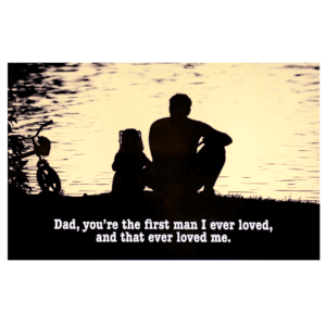 A father and his children sitting on the shore of a lake.