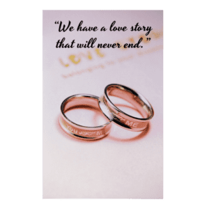 Two wedding rings sitting on top of a card.
