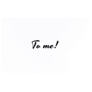 A green background with the word to me written in black ink.