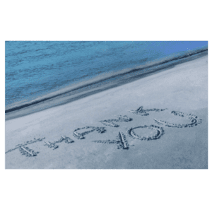 A beach with sand writing in the sand