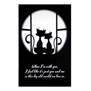 Two cats sitting on a window sill looking out at the moon.
