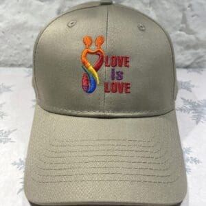 A baseball cap with the words love is love embroidered on it.