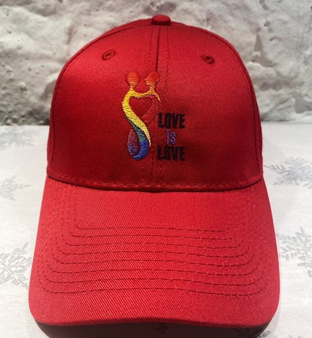 A red hat with the words " love is love ".