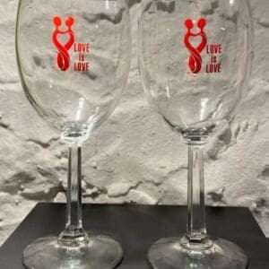 Two wine glasses sitting on top of a table.
