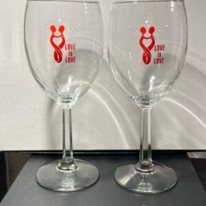 Two wine glasses sitting on top of a table.