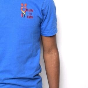 A man wearing a blue shirt with an embroidered logo.