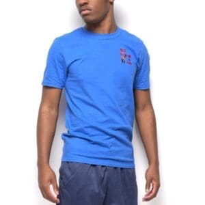 A man wearing blue shorts and a t-shirt.