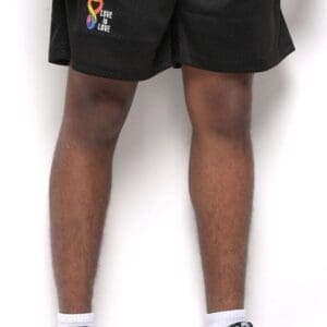 A person wearing black shorts and white socks.