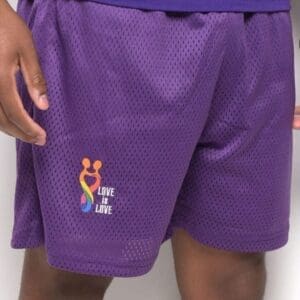A person wearing purple shorts and a white shirt