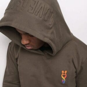 A man wearing a brown hoodie with an orange and blue logo.