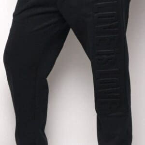 A person wearing black pants and shoes