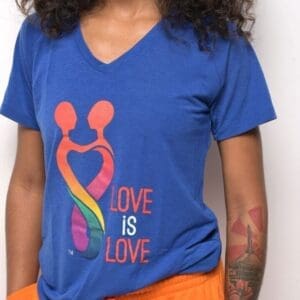 A woman wearing an orange and blue shirt with the words 